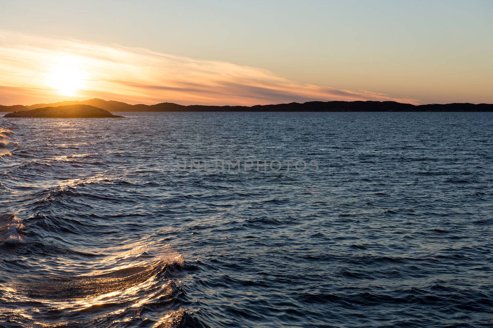 Ocean landscape in the arctic with sunset at an evening