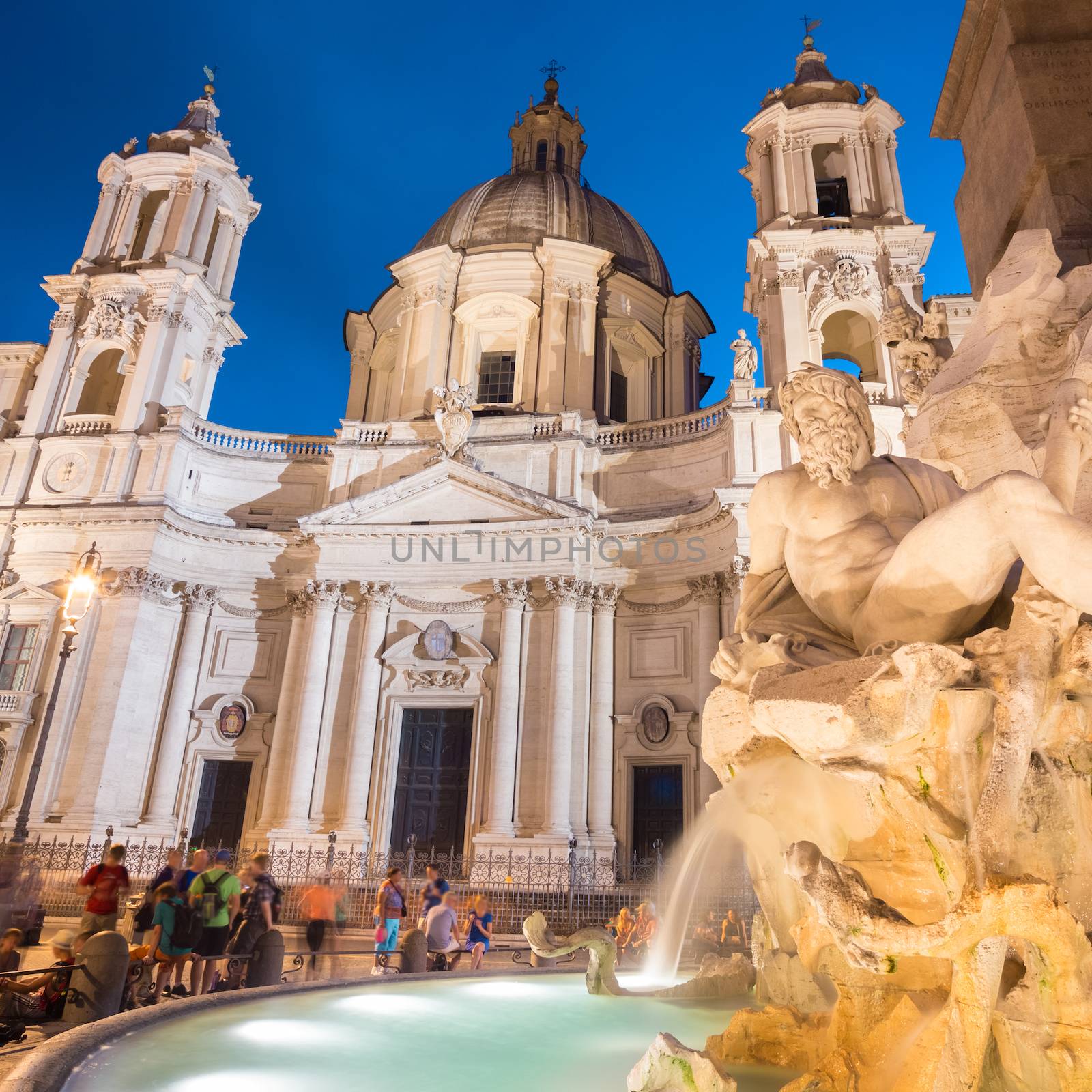 Fountain of the four Rivers and SantAgnese in Agone on Navona square in Rome, Italy, Europe shot at dusk.