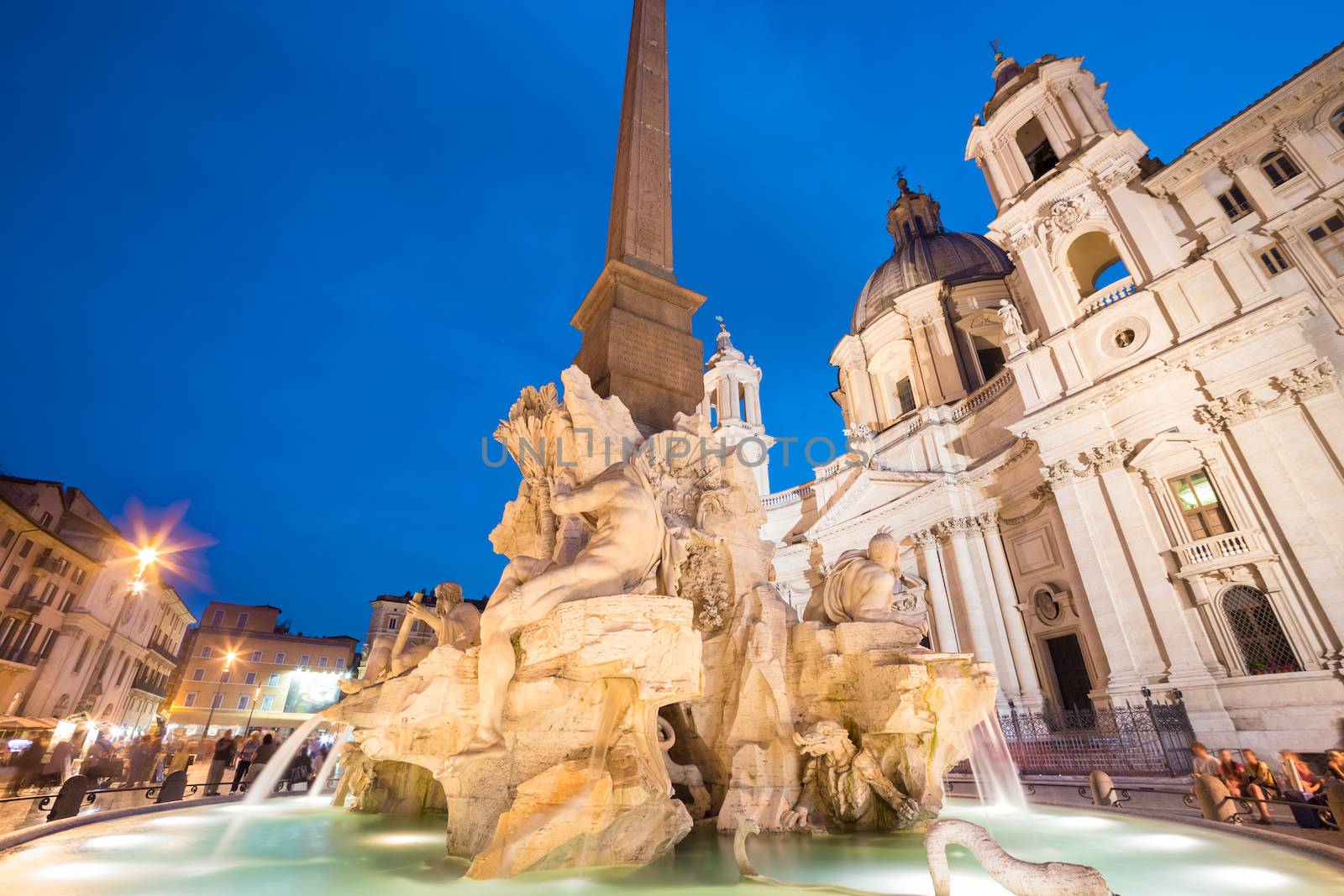 Fountain of the four Rivers and SantAgnese in Agone on Navona square in Rome, Italy, Europe shot at dusk.