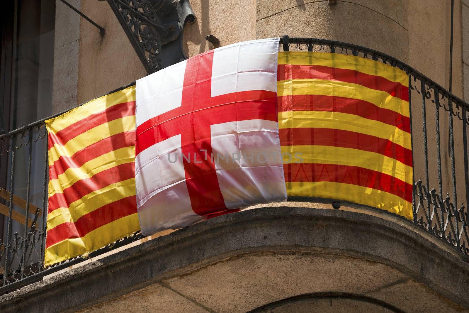 Flag of Catalonia striped red and yellow and Barcelona flag with the cross of Saint George in Barcelona, Catalonia, Spain