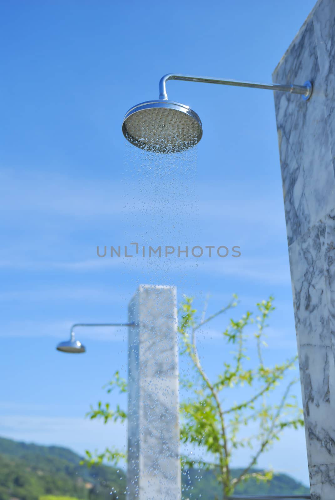 Outdoor shower at swimming pool and beach. The place you get clean after a nice day on the beach.