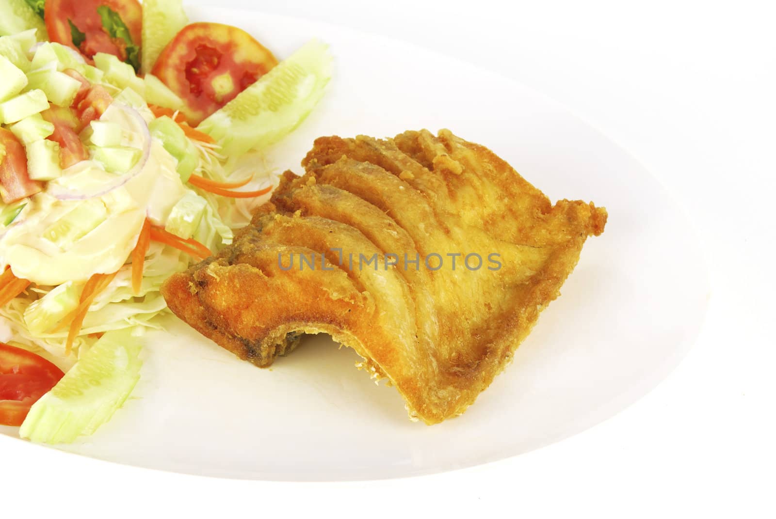 Fish dish - deep fried fish with vegetable salad on white