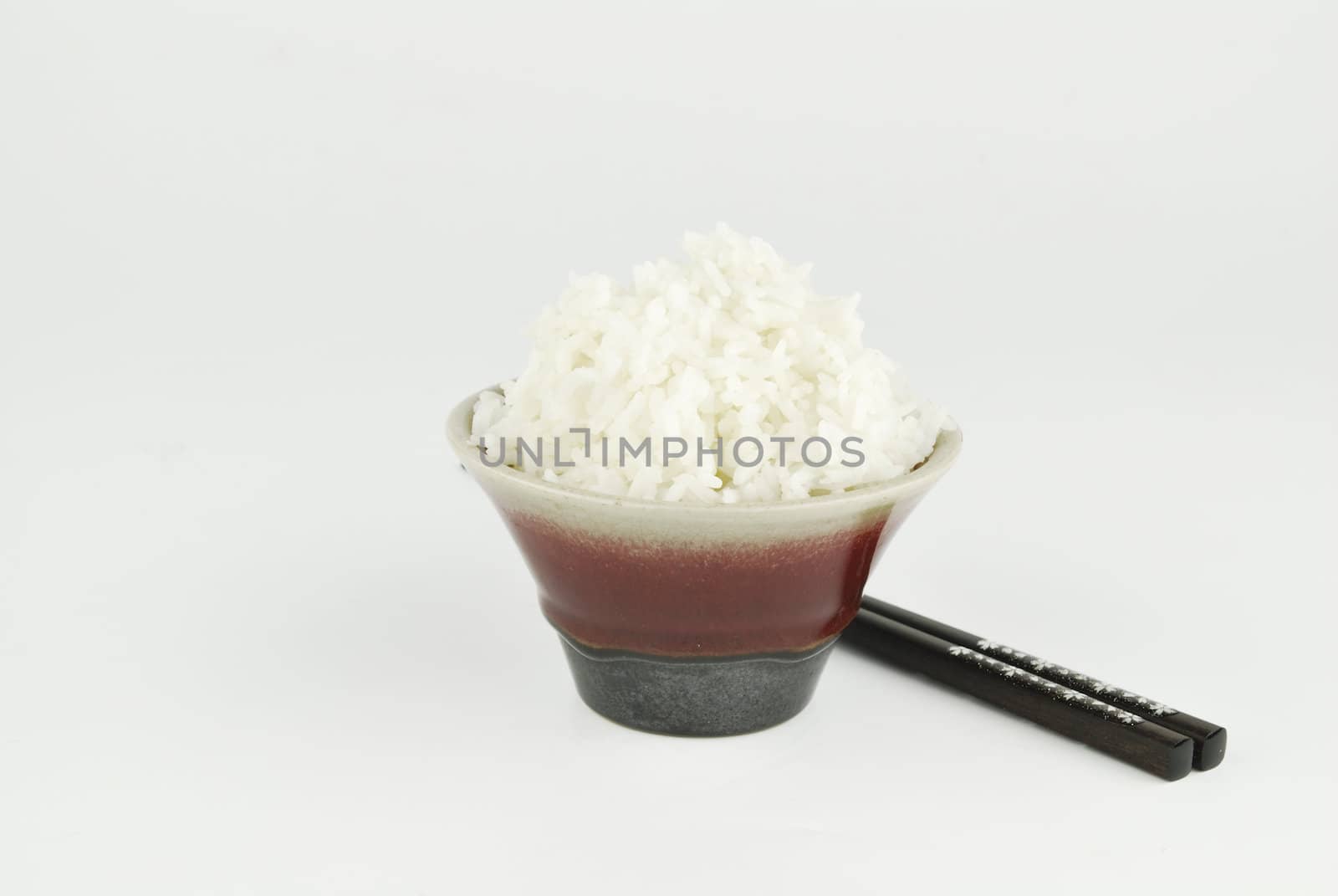 Rice in bowl and chopstick on white background