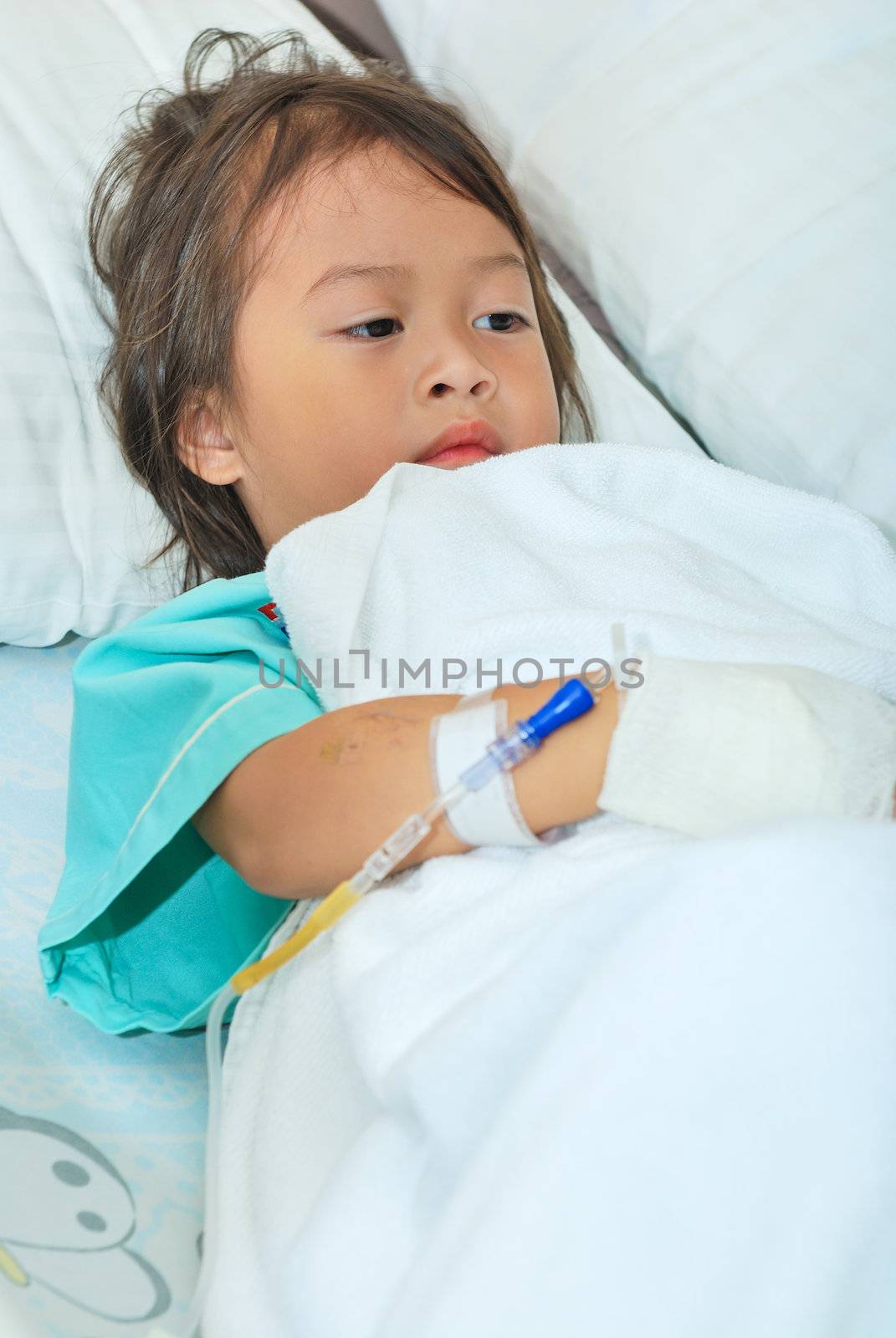 Sick little girl in hospital bed