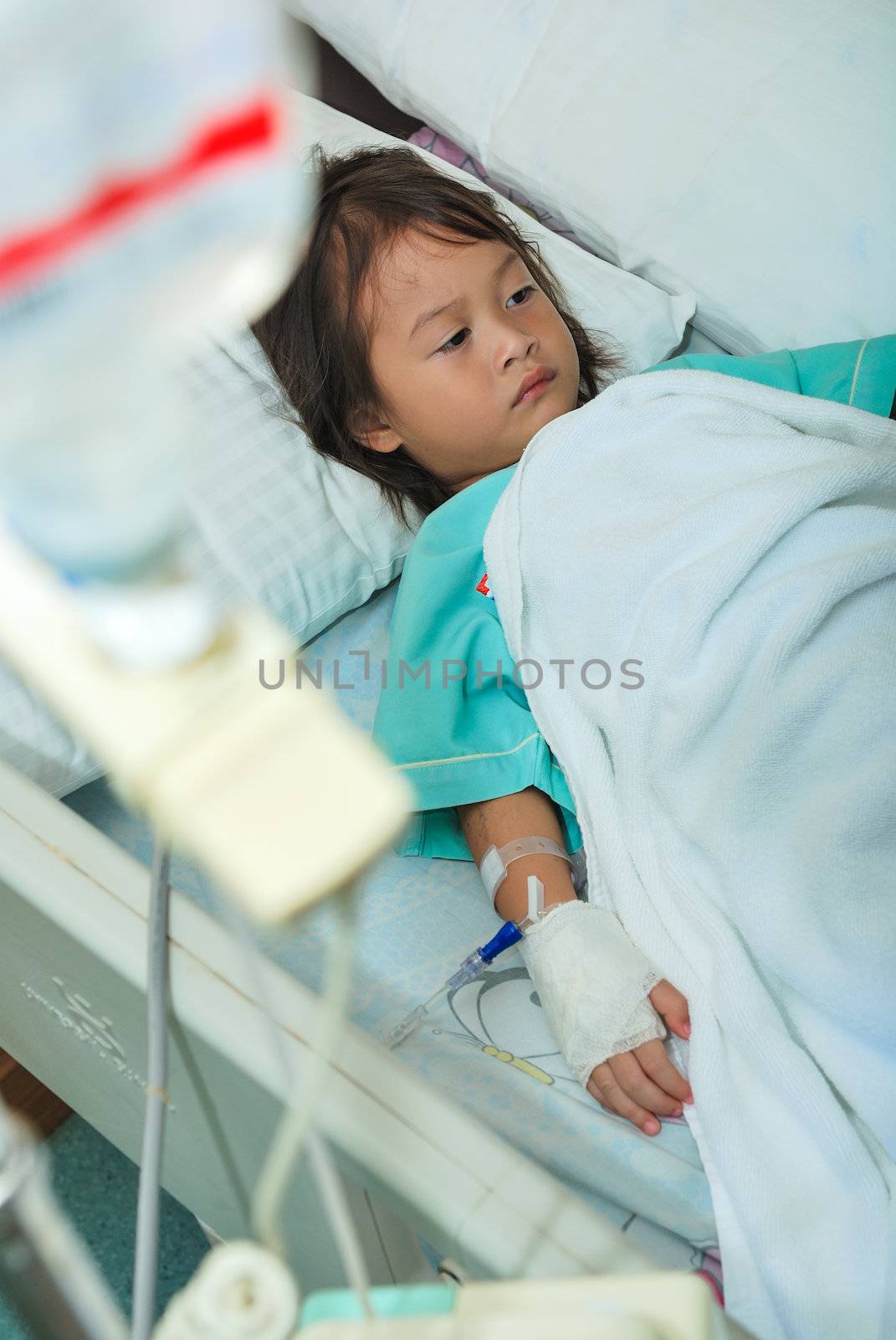 Sick little girl in hospital bed