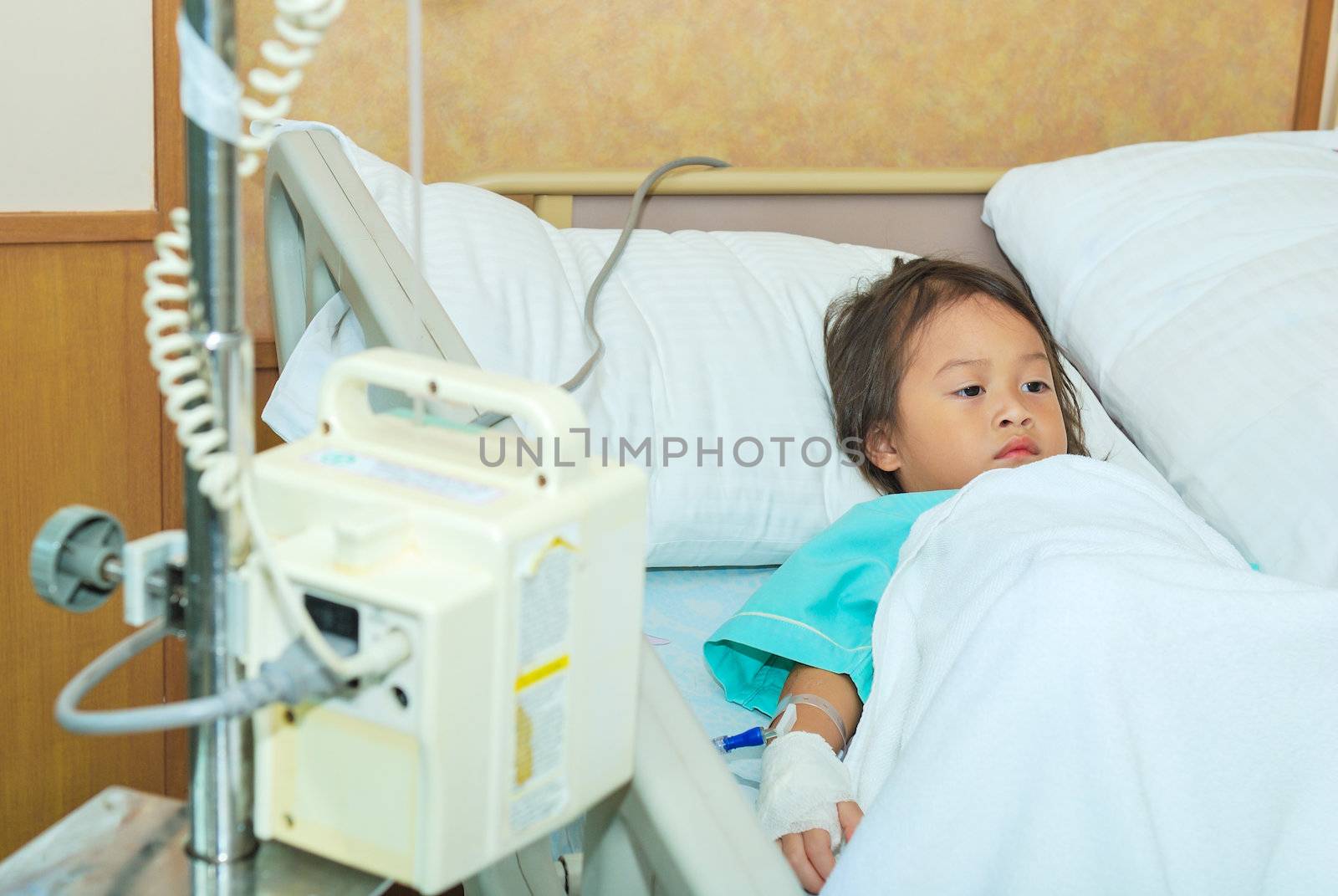 Sick little girl in hospital bed