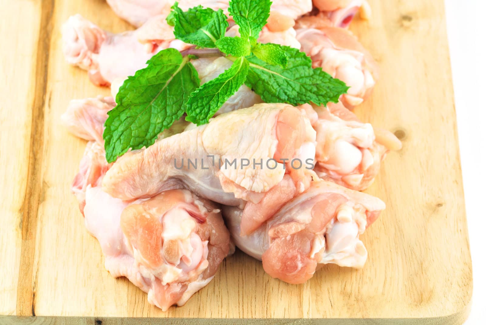 Chicken wing meat on chop board by teen00000