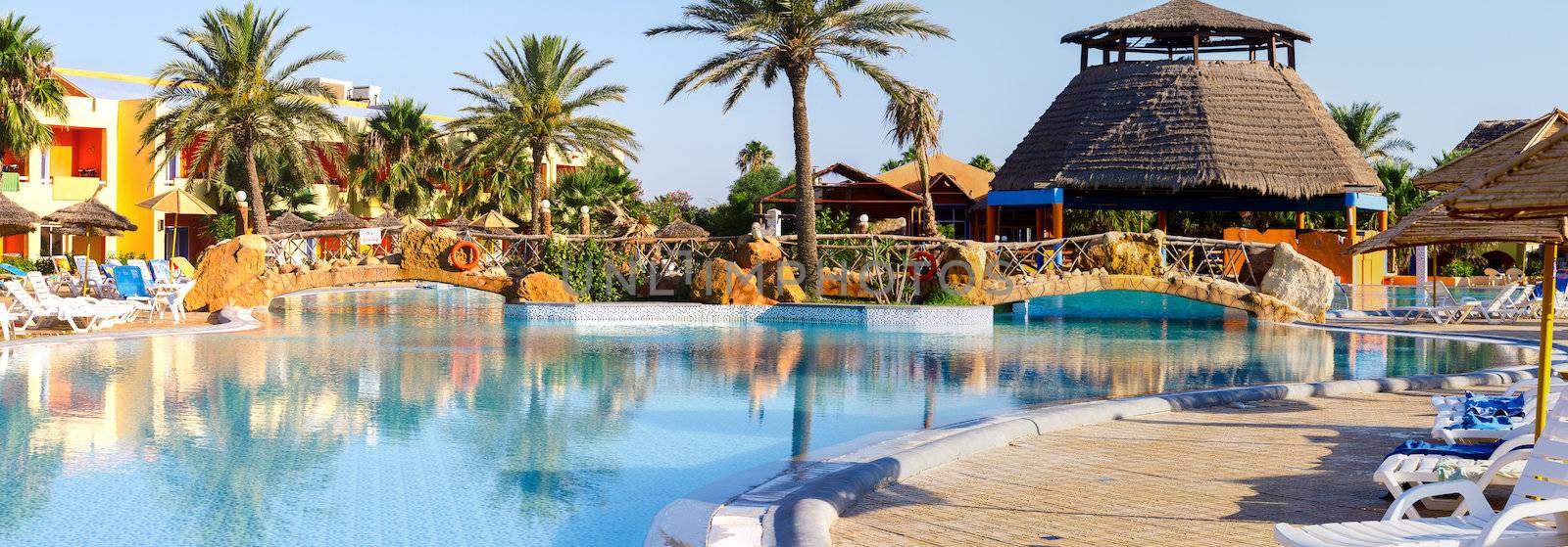 sun lounger on swimming pool with nobody in tunisian ressort Borj Cedria, Caribbean World
