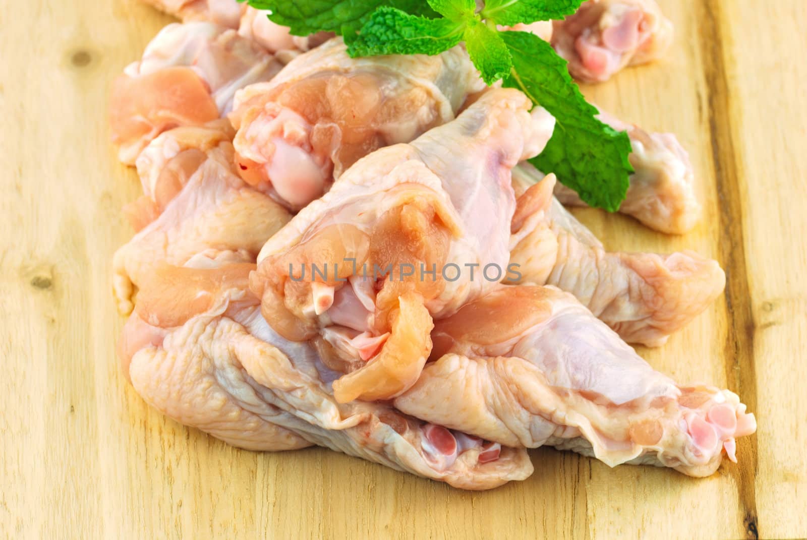 Chicken wing meat on chop board by teen00000