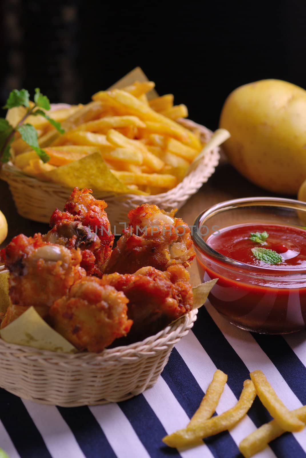 fried chicken wings with french fries and ketchup