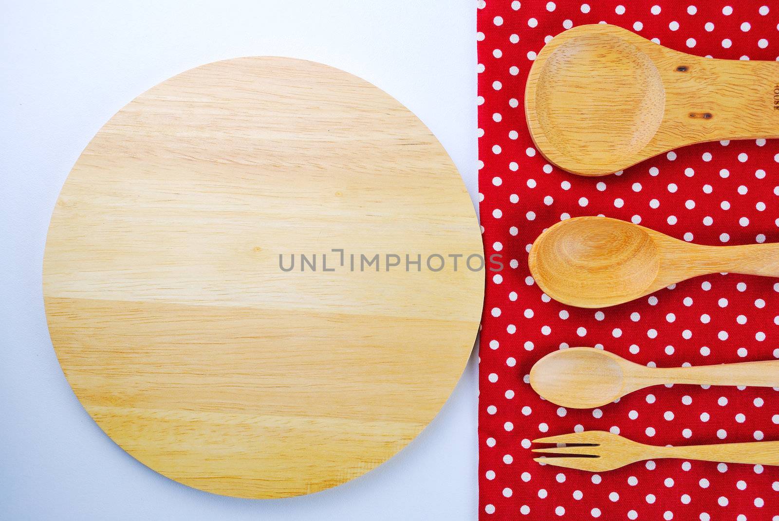 Wooden plate, tablecloth, spoon, fork on table background  by teen00000