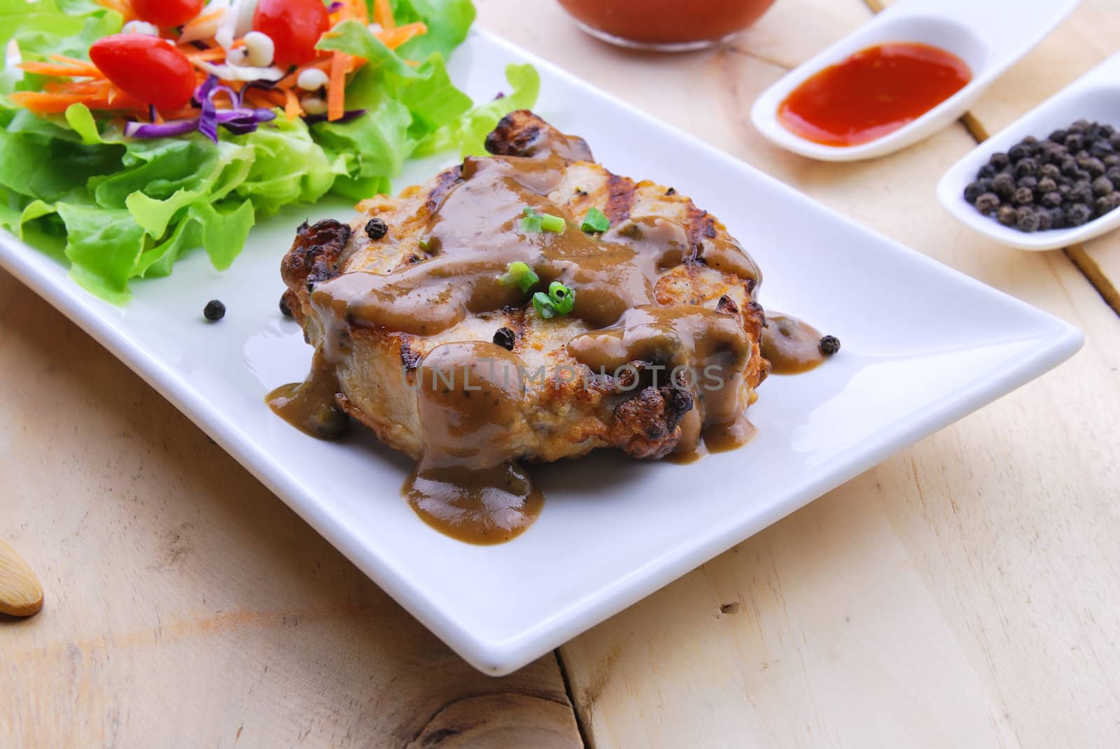 Grilled steaks, pork with pepper gravy and vegetable salad