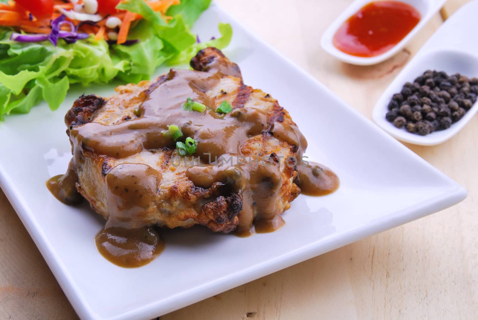 Grilled steaks, pork with pepper gravy and vegetable salad