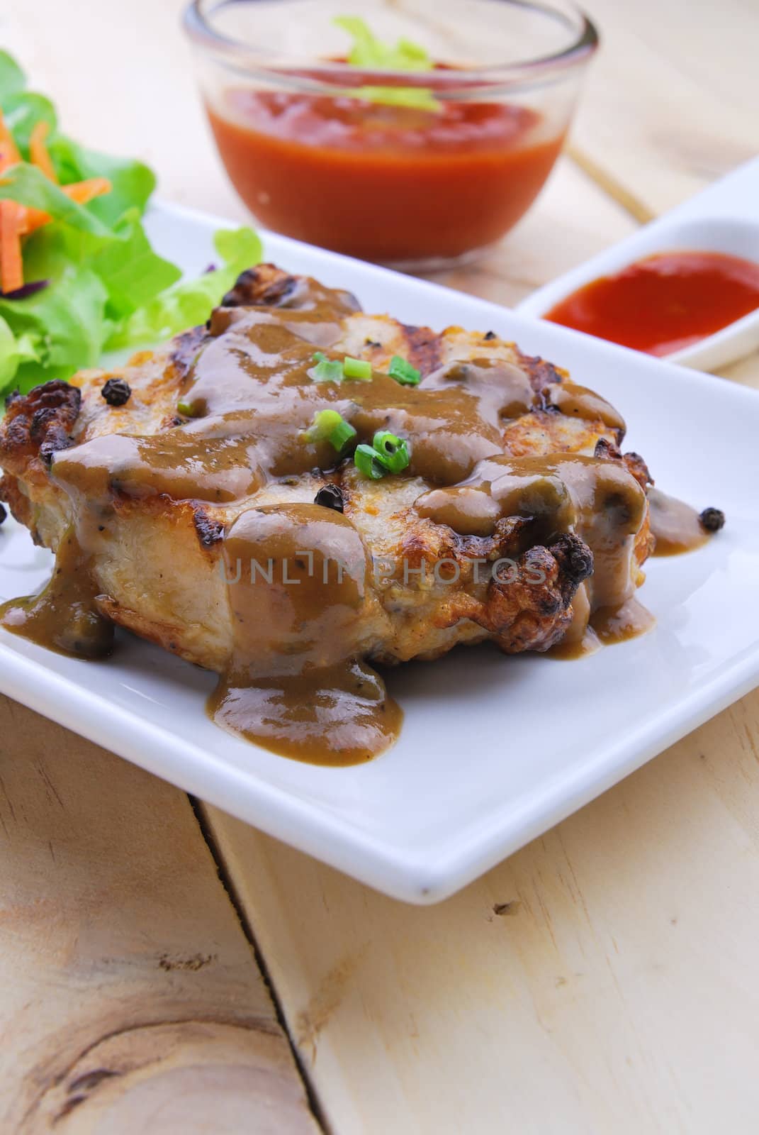 Grilled steaks, pork with pepper gravy and vegetable salad