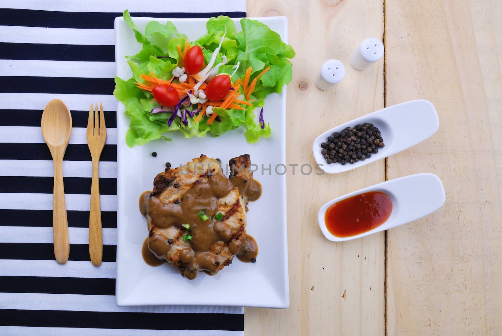 Grilled steaks, pork with pepper gravy and vegetable salad