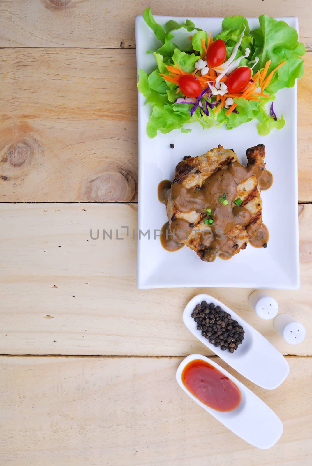 Grilled steaks, pork with pepper gravy and vegetable salad