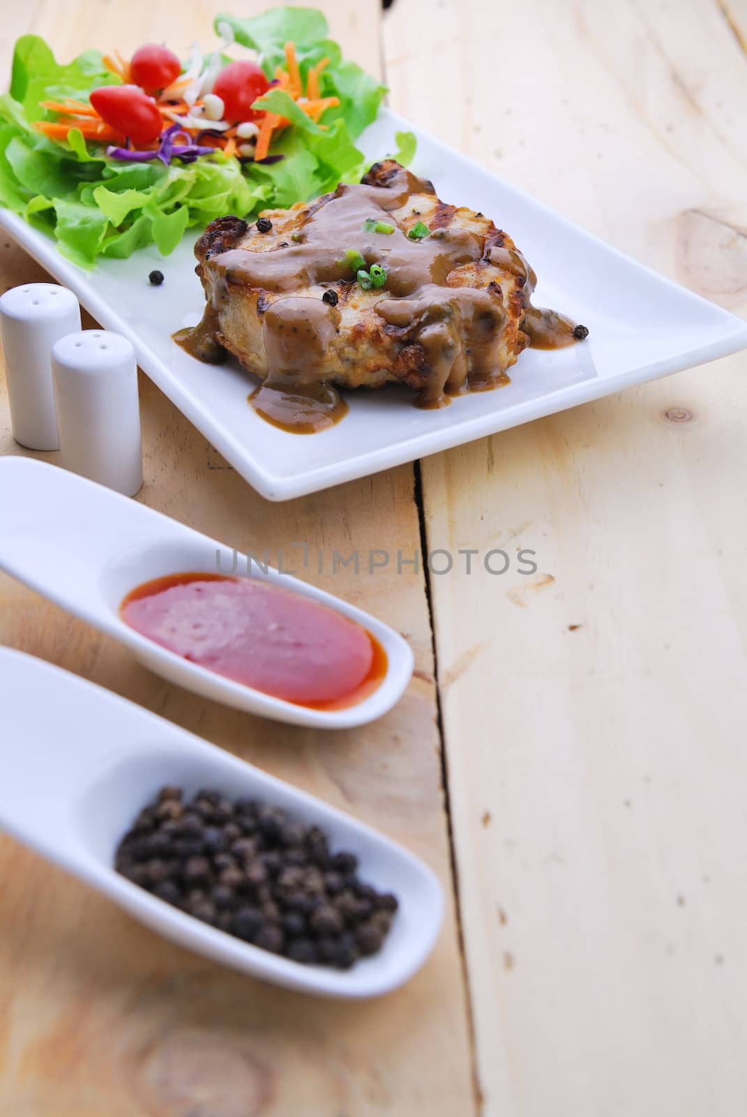 Grilled steaks, pork with pepper gravy and vegetable salad