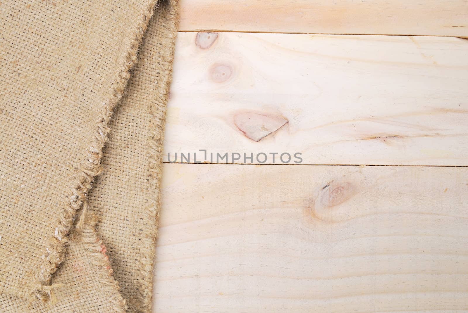 Gunny sack texture and wood plank table background