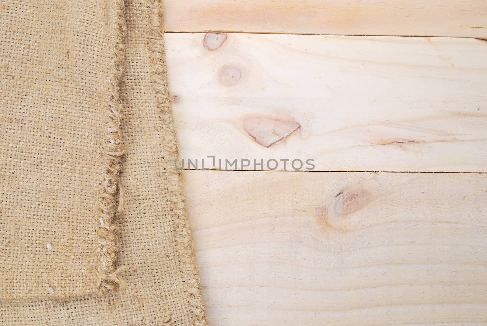 Gunny sack texture and wood plank table background