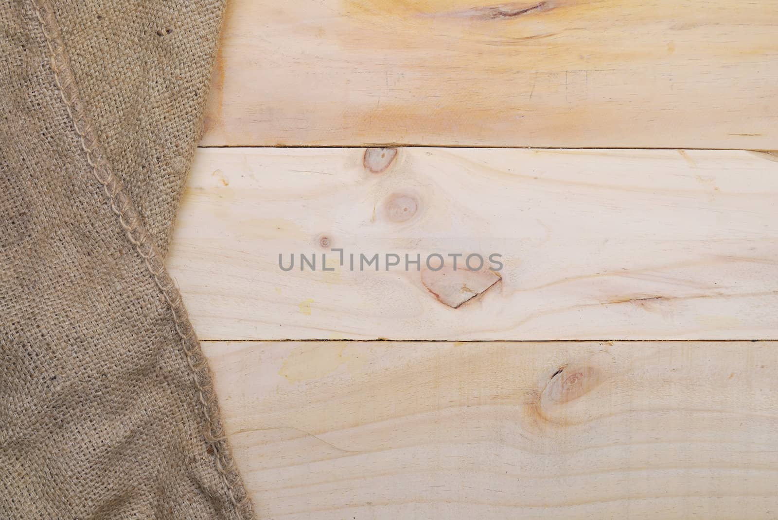 Gunny sack texture and wood plank table background