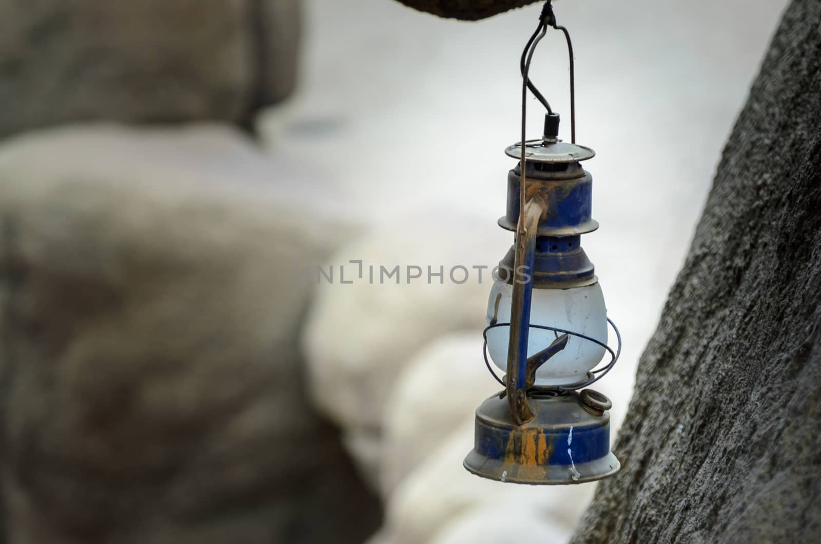 Old oil lamp hangs in cave by frankhoekzema