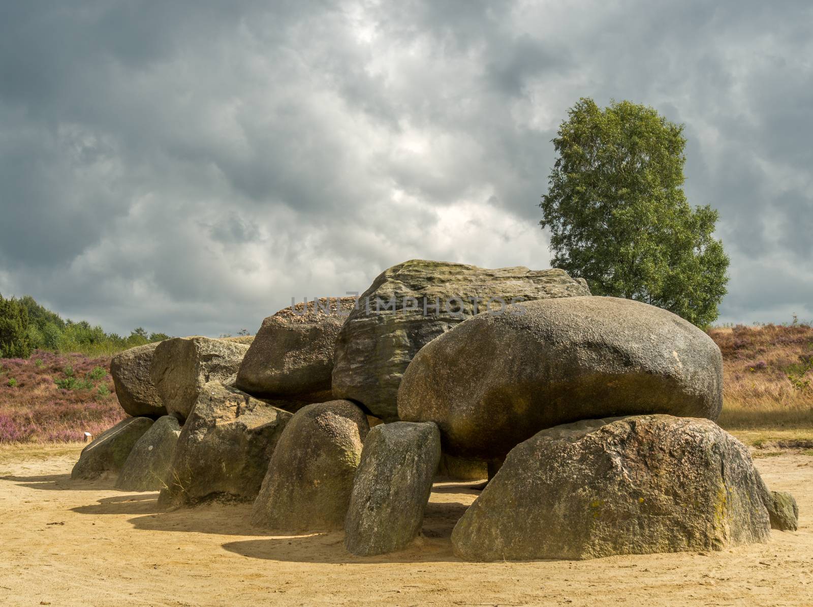 Dramatic sky over megalithic stones in Drenthe, Netherlands. Dark clouds give dramatic view