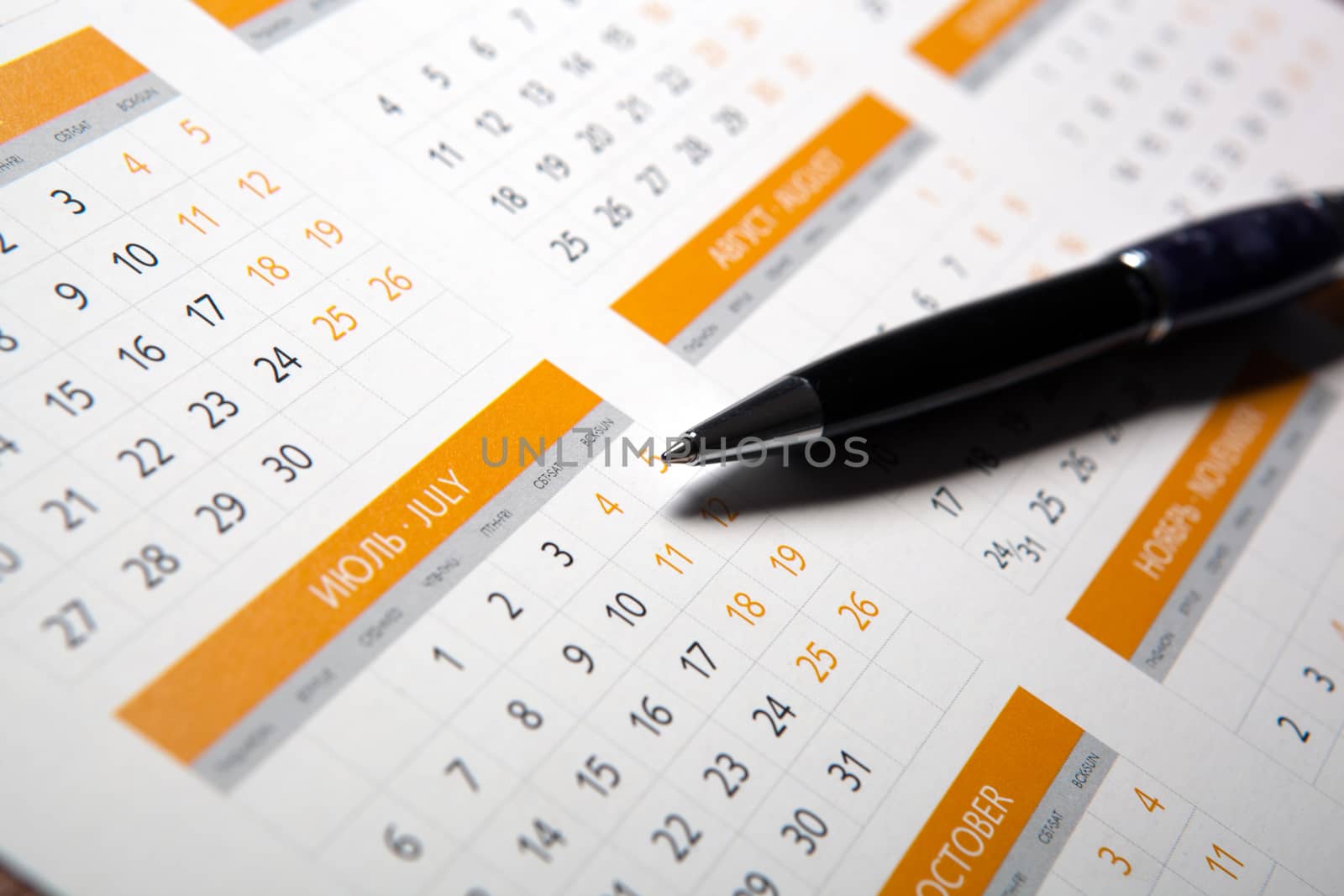 wall calendar with pen closeup and macro