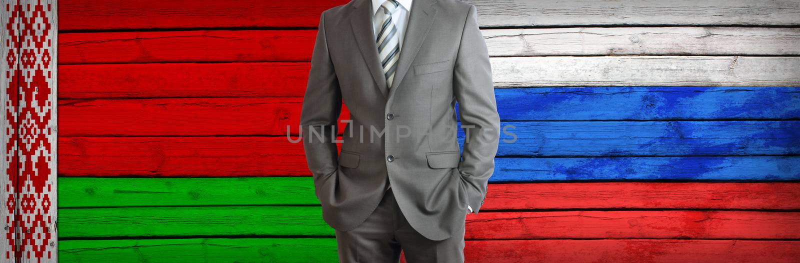 Businessman in a suit. Belarus and Russian flags as background. Concept of business