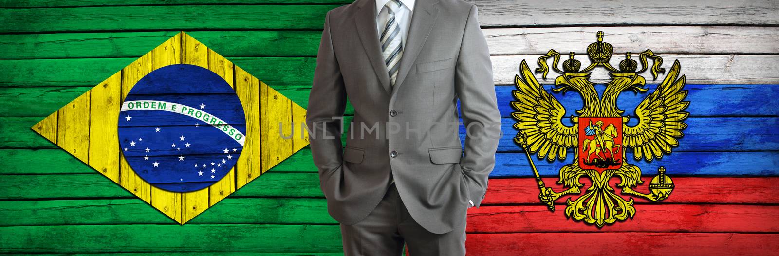 Businessman in a suit. Brazil and Russian flags as background. Concept of business