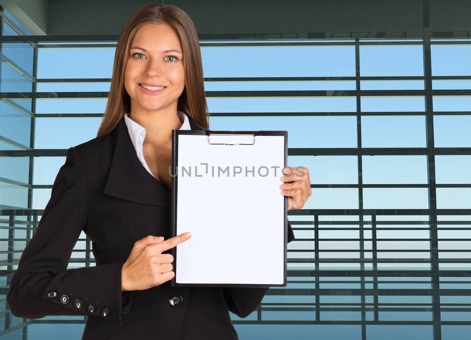 Businesswoman holding paper holder. Large window in the airport terminal as backdrop