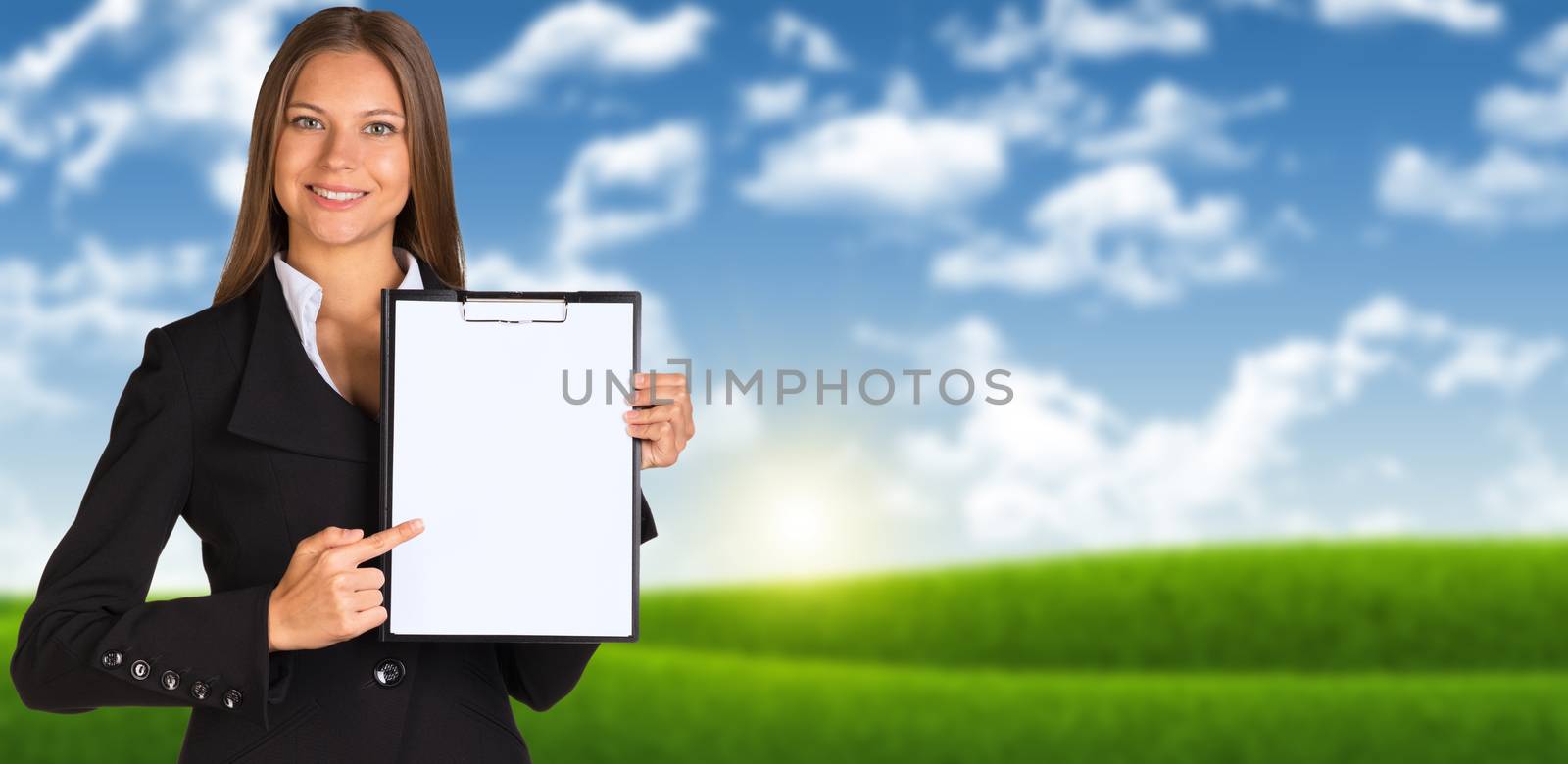 Businesswoman holding paper holder. Blue sky and green grass as backdrop