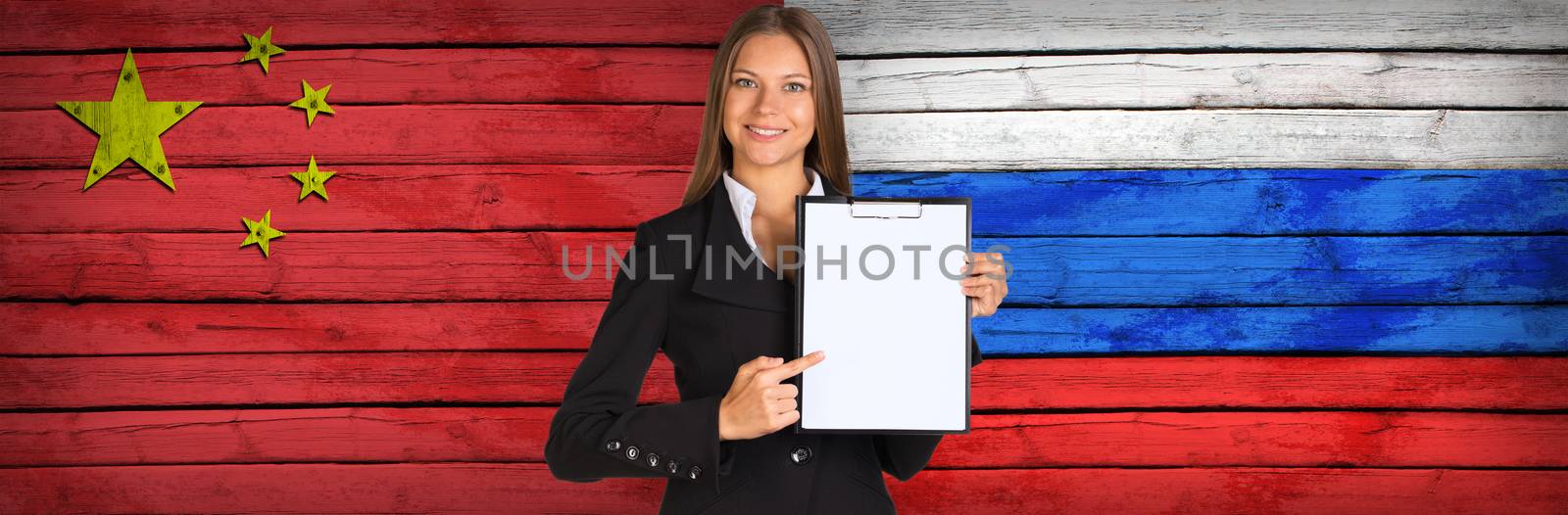 Businesswoman holding paper holder. China and Russian flags as backdrop