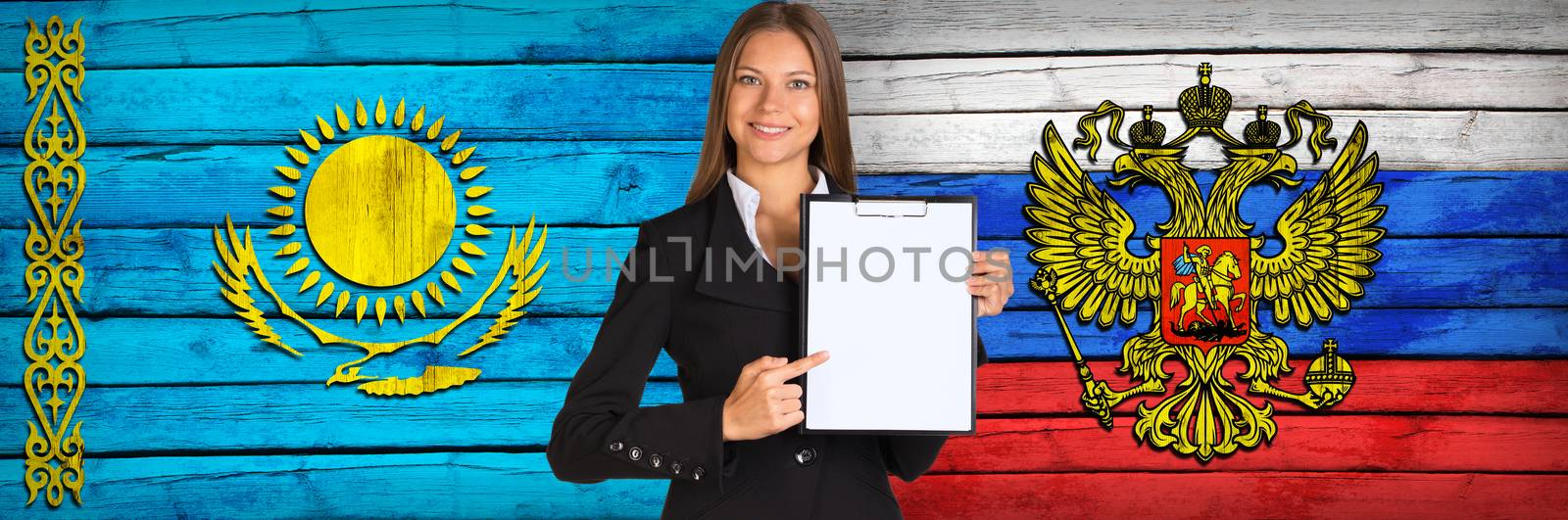 Businesswoman holding paper holder. Kazakhstan and Russian flags as backdrop
