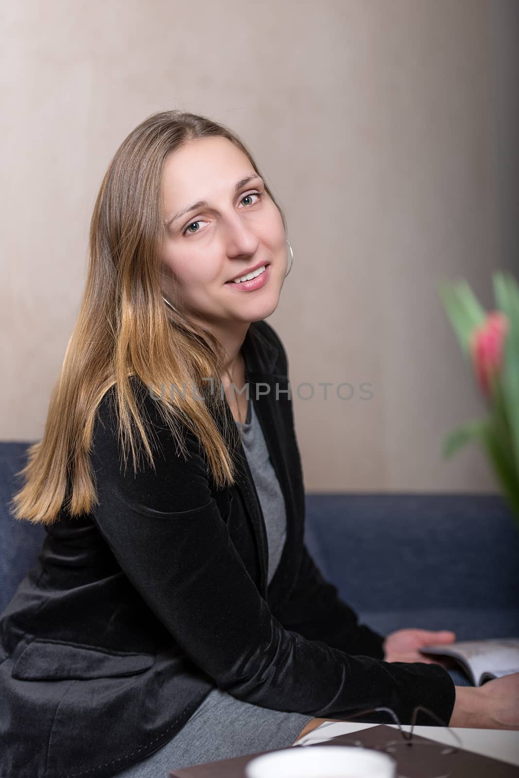 young woman reading magazine portrait studio shot by Nanisimova