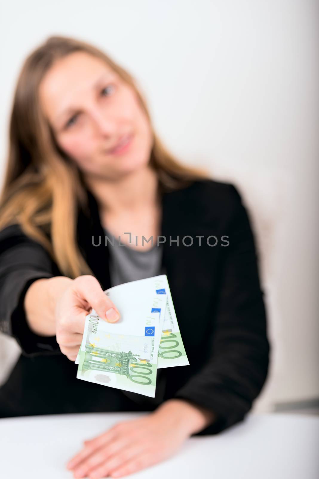 young woman giving money by Nanisimova