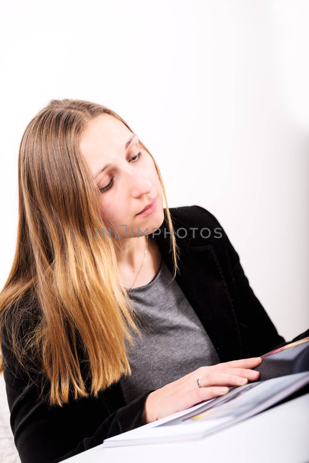 woman reading magazine by Nanisimova
