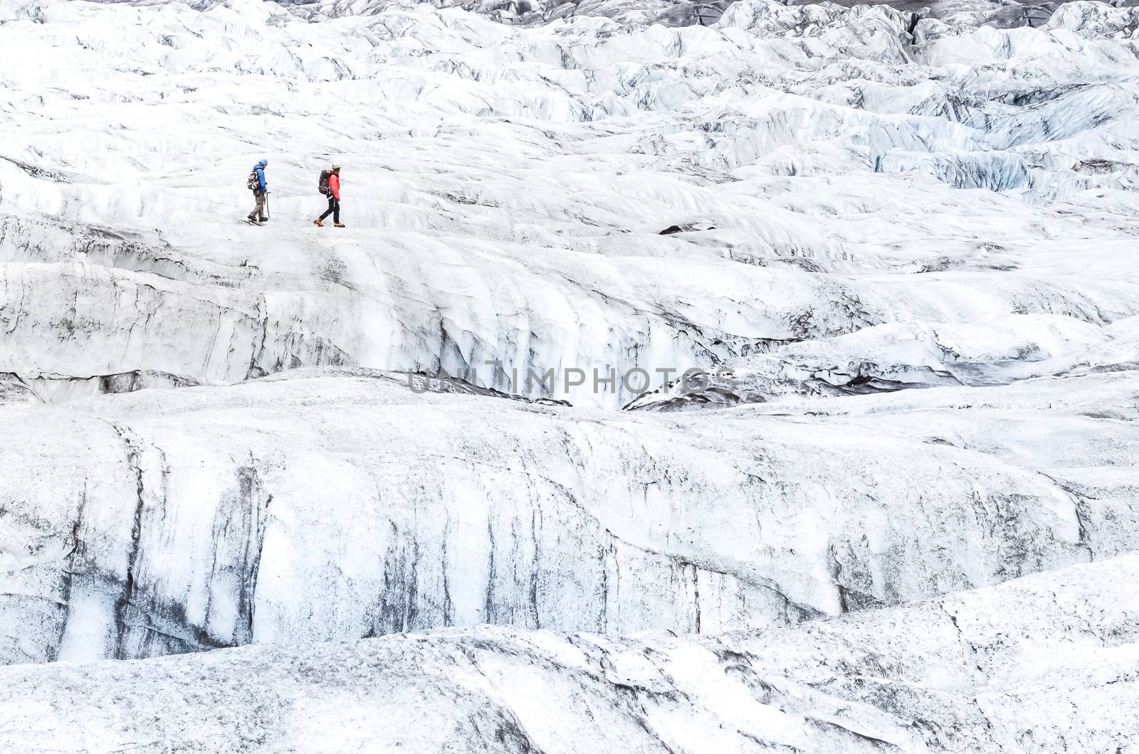 Two people trekking on ice Vatnajokull glacier, iceland