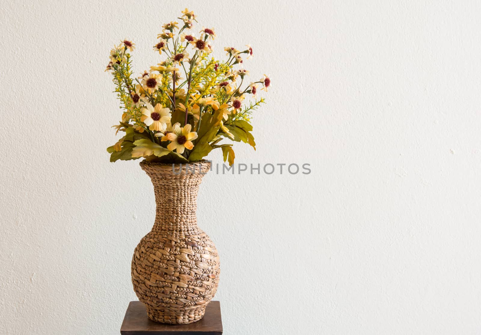 the beautiful flower with green leaves in the fabricate jar