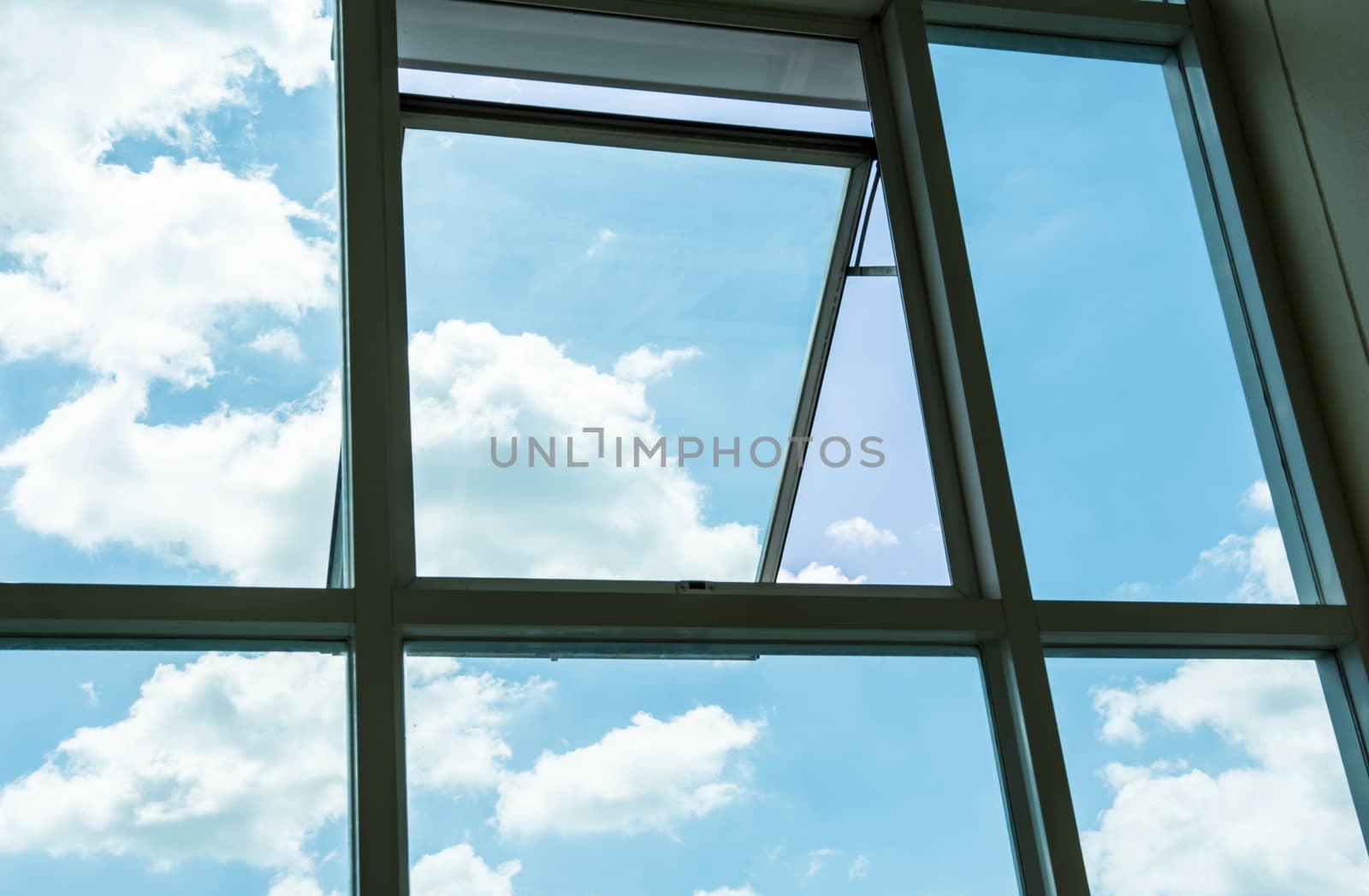 the beautiful creative blue sky with white cloud in the silhouette window frame