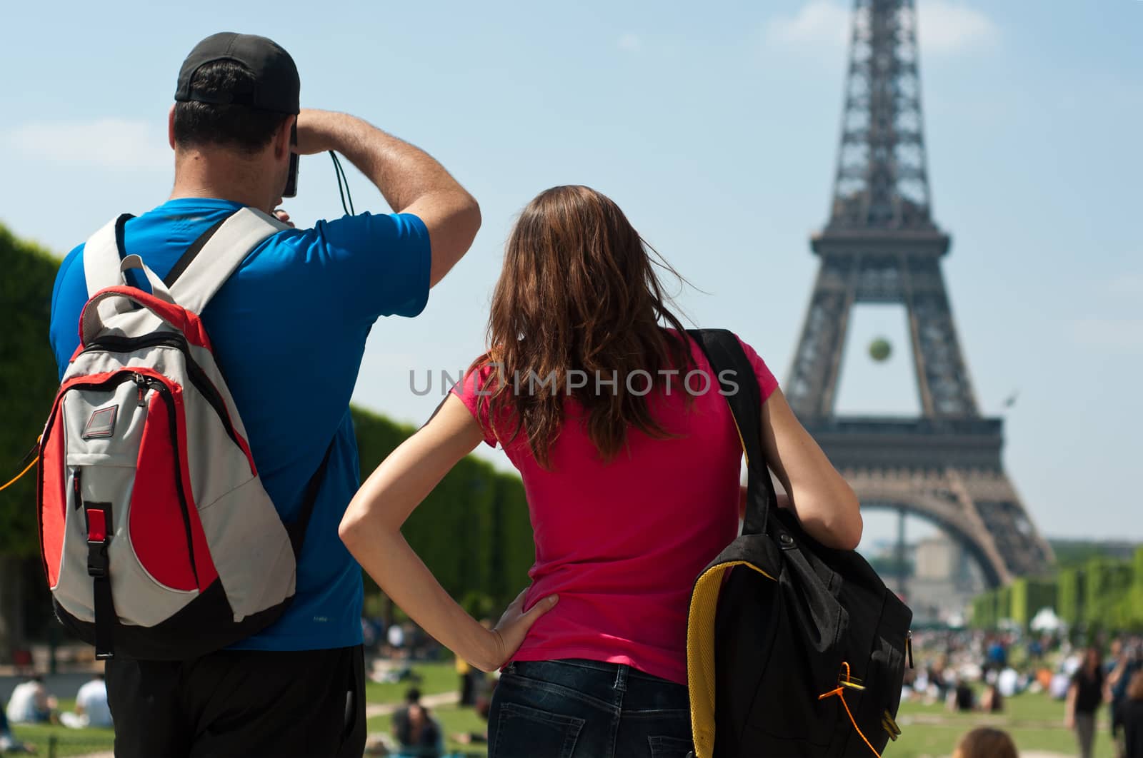 Tourists Eiffel tower in Paris by NeydtStock