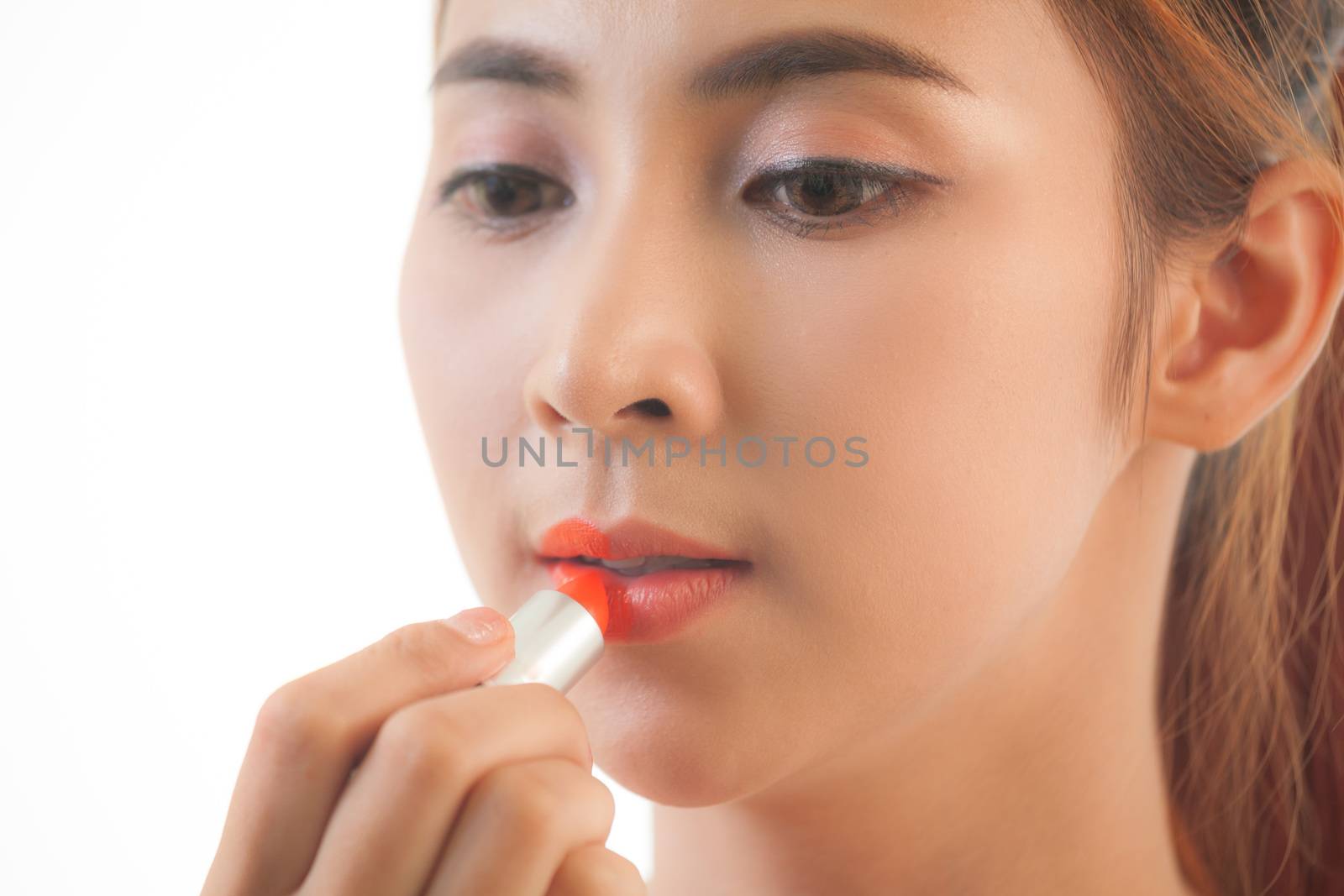 Young beautiful asian woman Applying lipstick