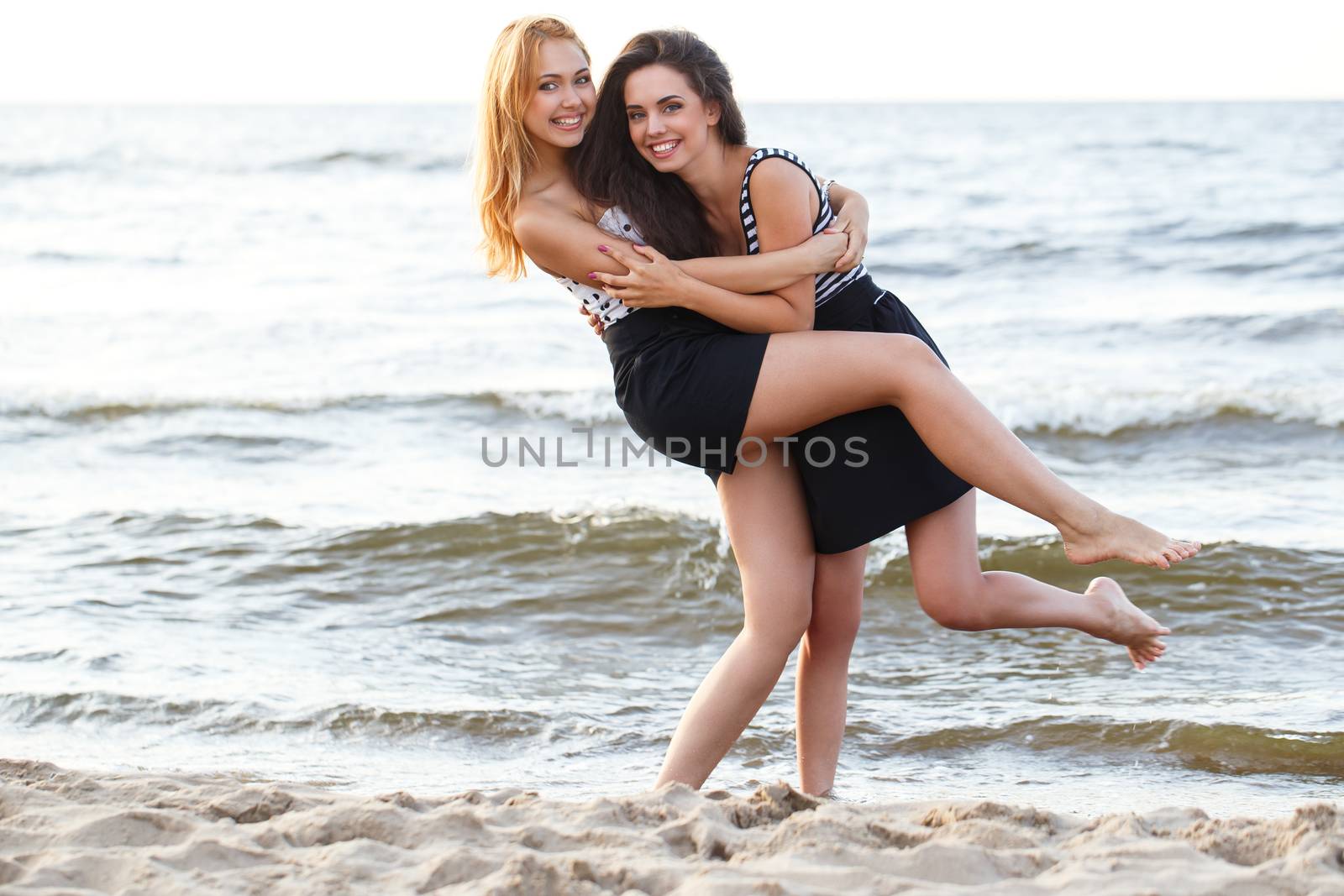 Summer, sea. Cute girls on the beach