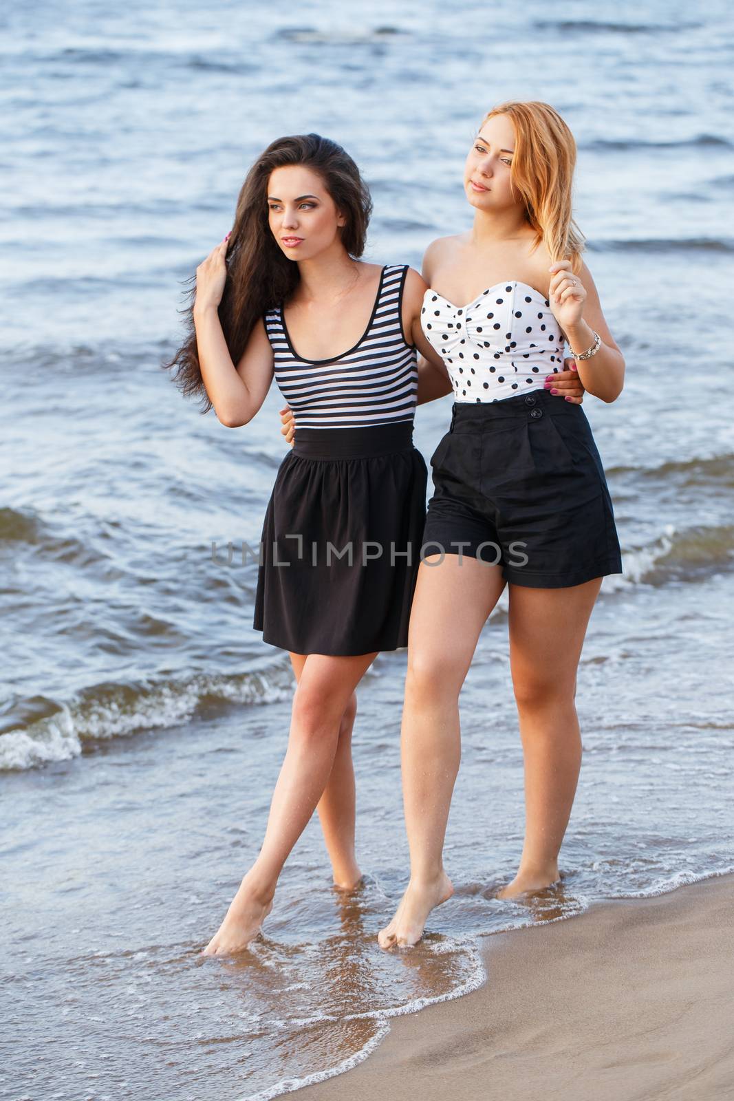 Summer, sea. Cute girls on the beach