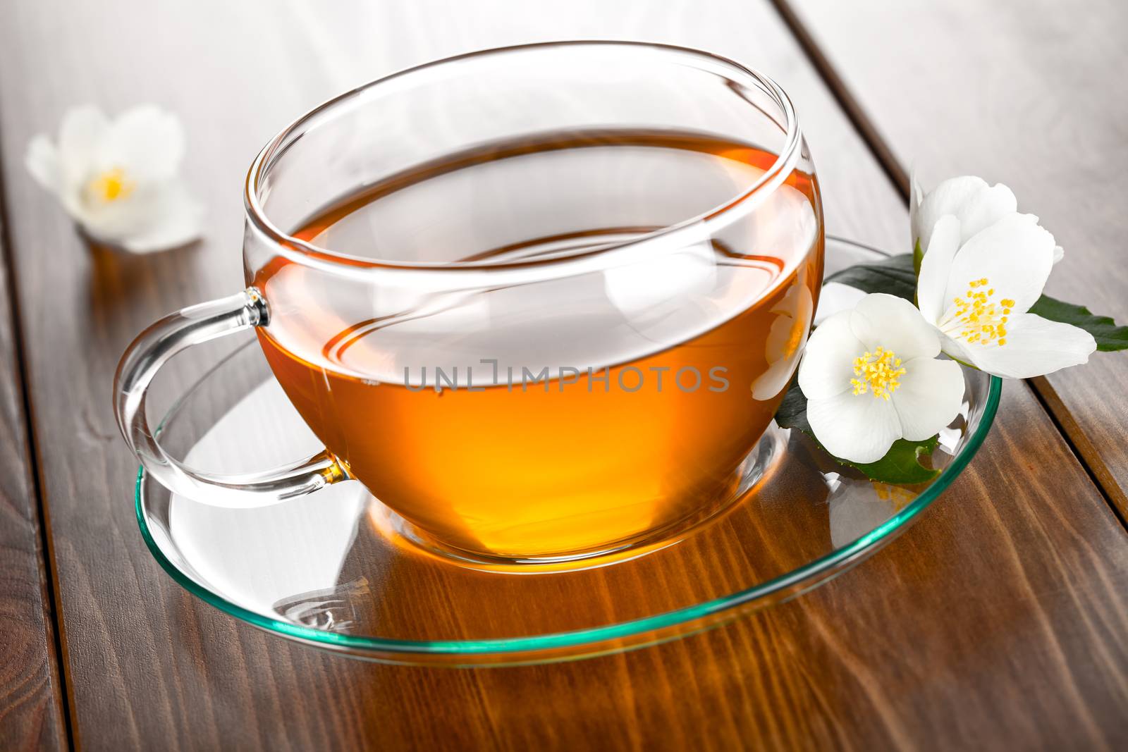 Jasmine tea with jasmine herb flower on table background