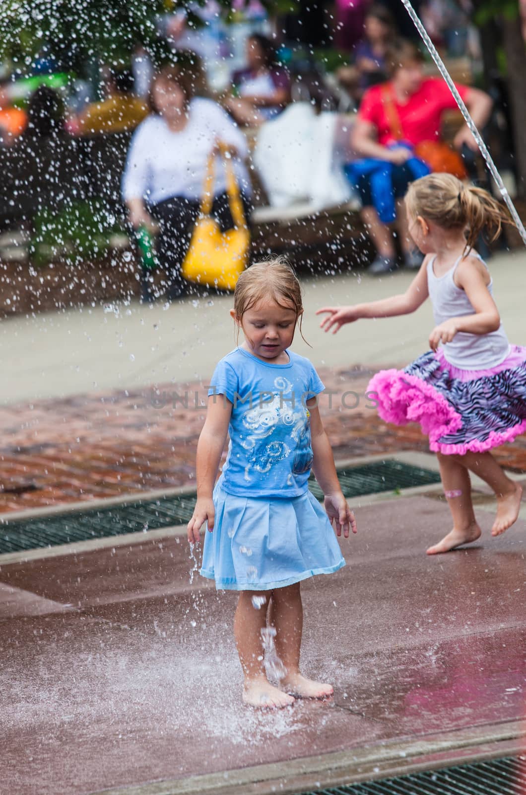 DES MOINES, IA /USA - AUGUST 10: Unidentified young girl plays in fountain at the Iowa State Fair on August 10, 2014 in Des Moines, Iowa, USA.