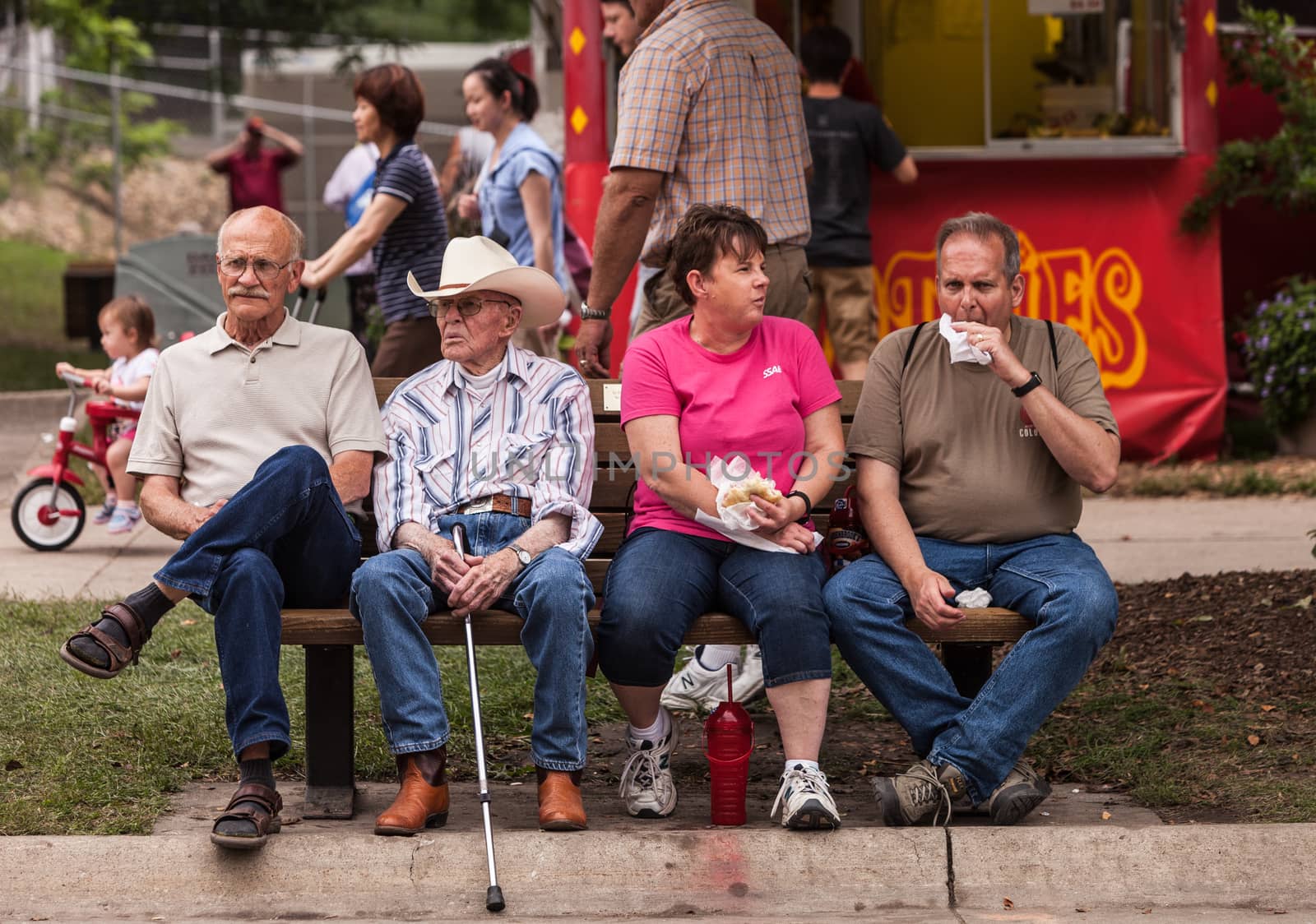 DES MOINES, IA /USA - AUGUST 10: Attendees at the Iowa State Fair. Unidentified people enjoy food at the Iowa State Fair on August 10, 2014 in Des Moines, Iowa, USA.