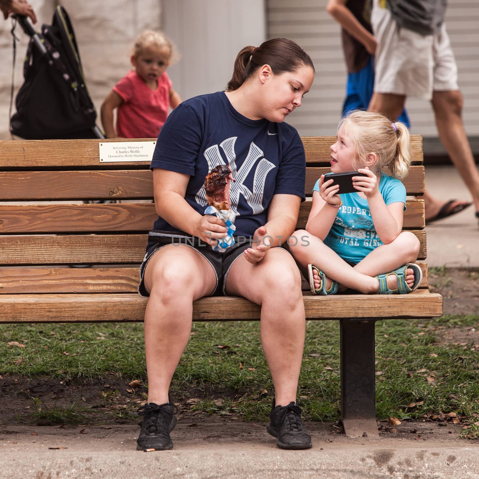 DES MOINES, IA /USA - AUGUST 10: Attendees at the Iowa State Fair. Unidentified girls look at smart phone at Iowa State Fair on August 10, 2014 in Des Moines, Iowa, USA.