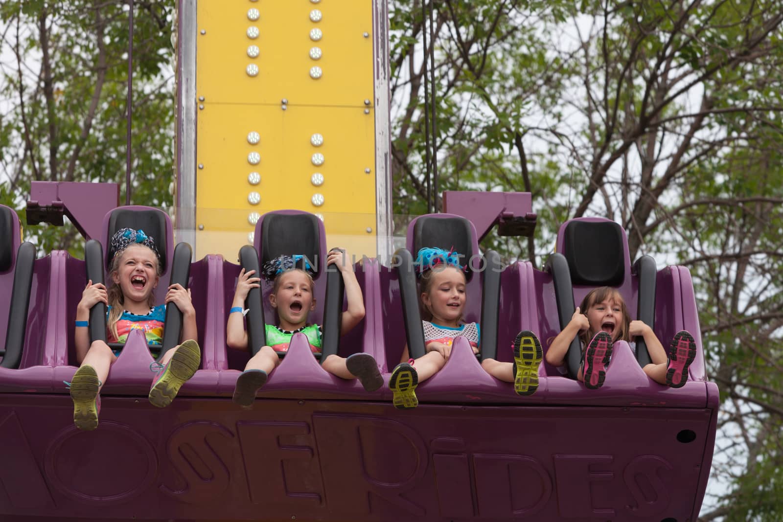 Girls on carnival ride at state fair by Creatista