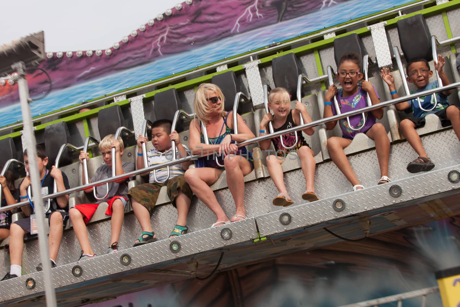 DES MOINES, IA /USA - AUGUST 10: Unidentified people enjoy a carnival thrill ride at the Iowa State Fair on August 10, 2014 in Des Moines, Iowa, USA.