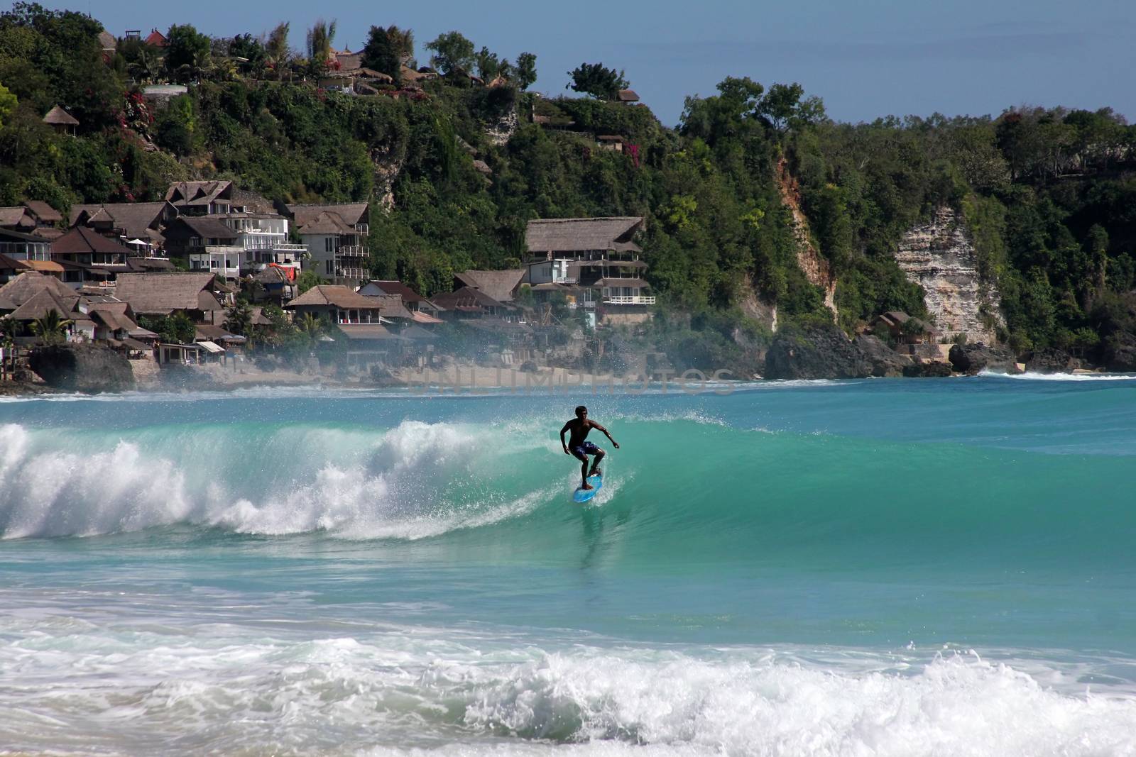 Young men - the surfer in ocean. Bali. Indonesia